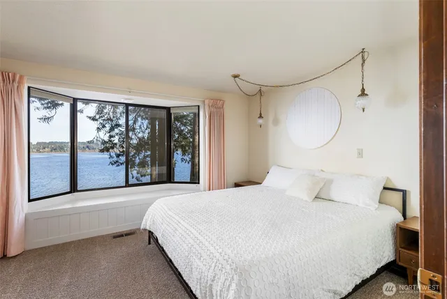 a view of a room with a large window and front door