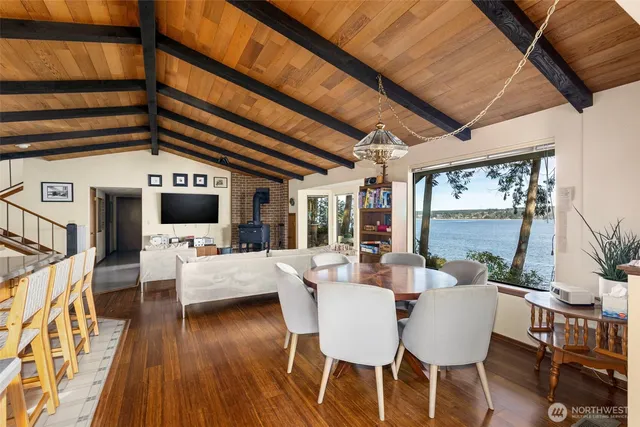 a dining room with furniture a chandelier and a flat screen tv