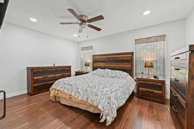 a bedroom with a bed and wooden floor