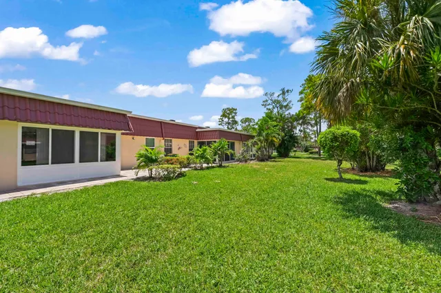 a view of house with backyard
