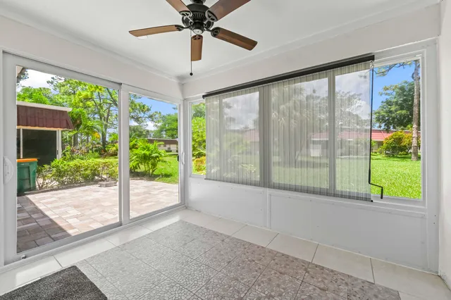 a view of an empty room with wooden floor and a floor to ceiling window