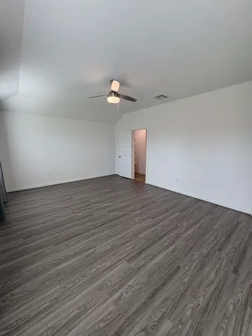 a view of a room with wooden floor