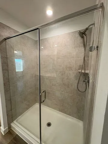 a view of empty room with wooden floor