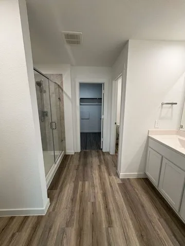 a view of hallway with wooden floor