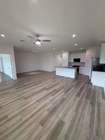 a kitchen with granite countertop a refrigerator and a sink