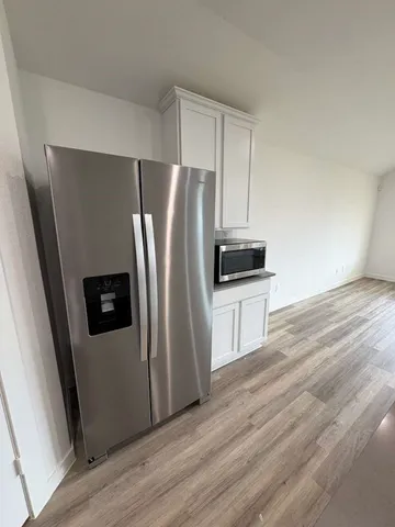 a large kitchen with kitchen island a stove a sink and a refrigerator