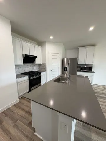a view of an empty room and wooden floor