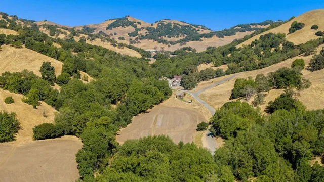 an aerial view of a house with a yard
