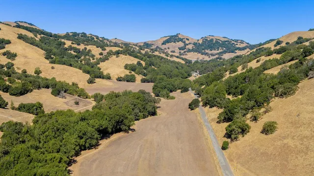 a view of a houses with mountains in the background