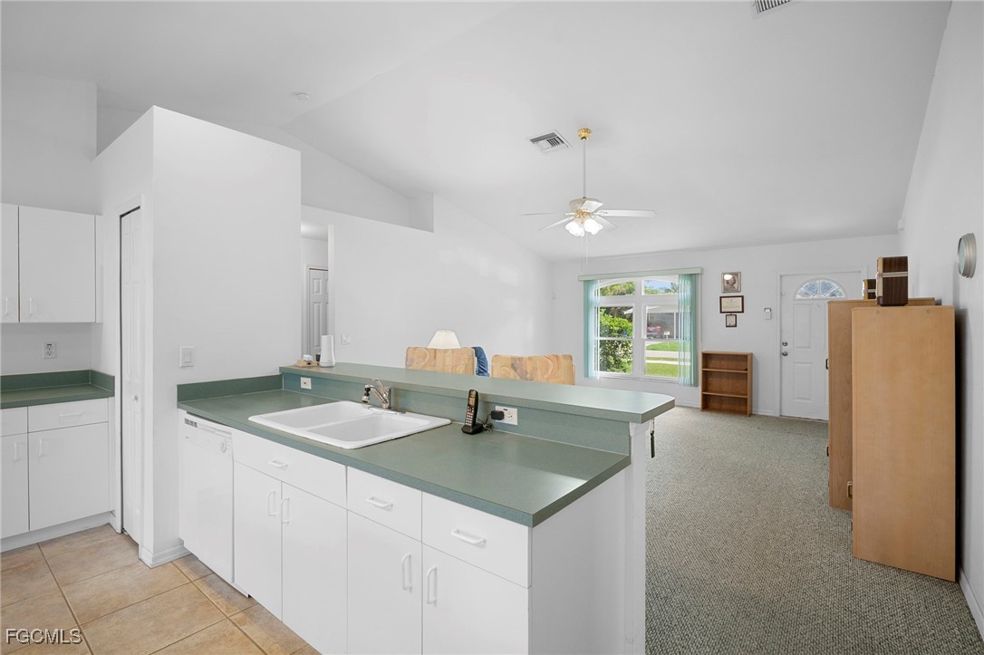 2932 Holly Road Fort Myers, FL 33901 - Photo 11 of 39 a bathroom with a granite countertop sink and a refrigerator