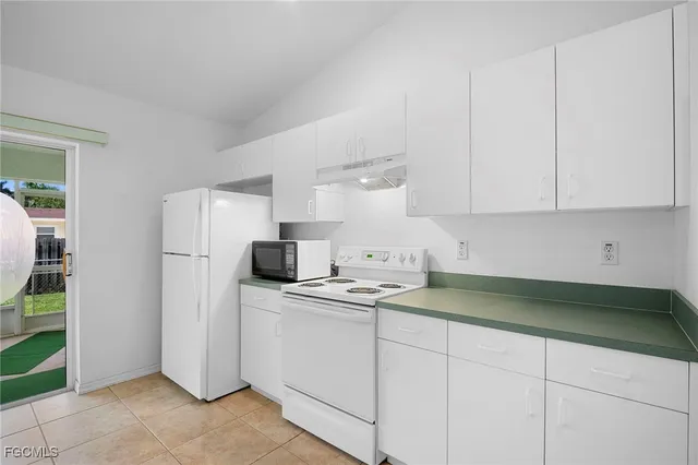 a kitchen with stainless steel appliances granite countertop a sink a refrigerator and a stove