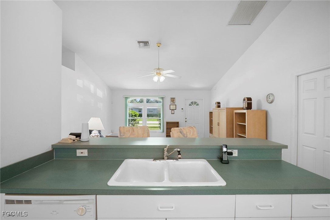 2932 Holly Road Fort Myers, FL 33901 - Photo 17 of 39 a kitchen with a sink dishwasher and a stove with wooden floor