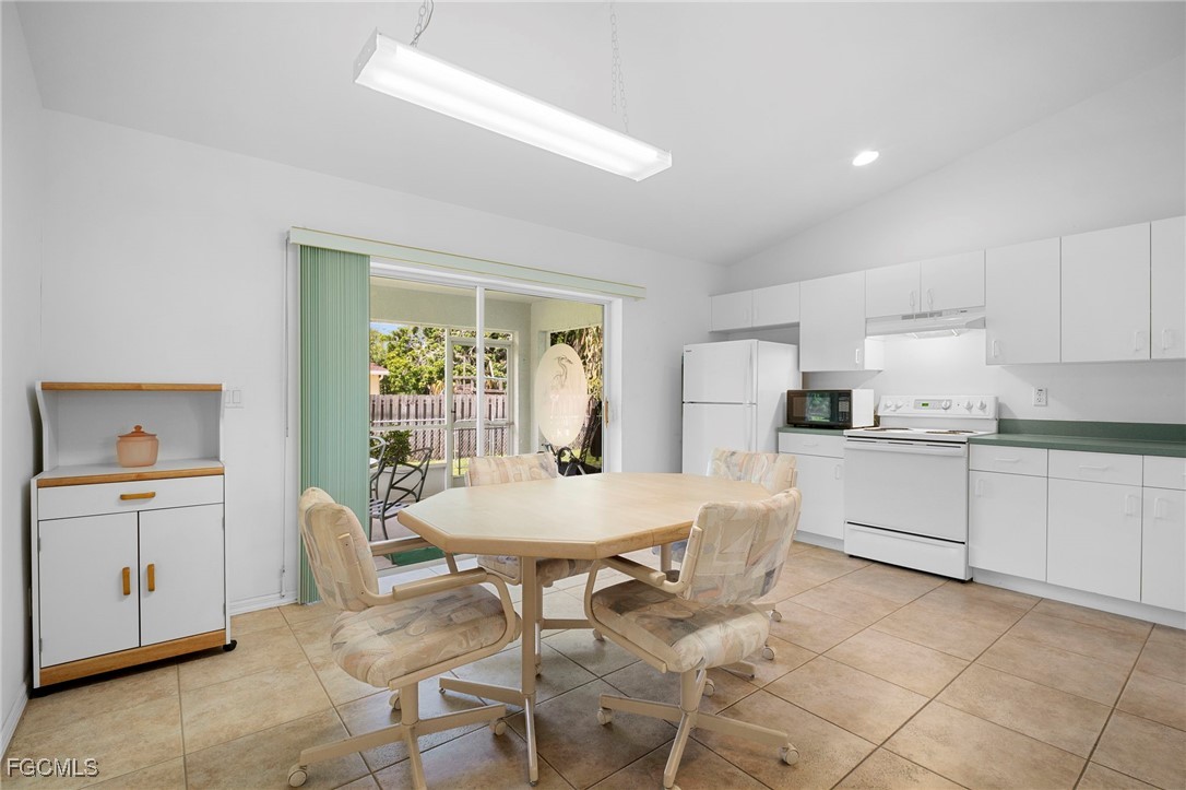 2932 Holly Road Fort Myers, FL 33901 - Photo 18 of 39 a kitchen with granite countertop white cabinets and stainless steel appliances