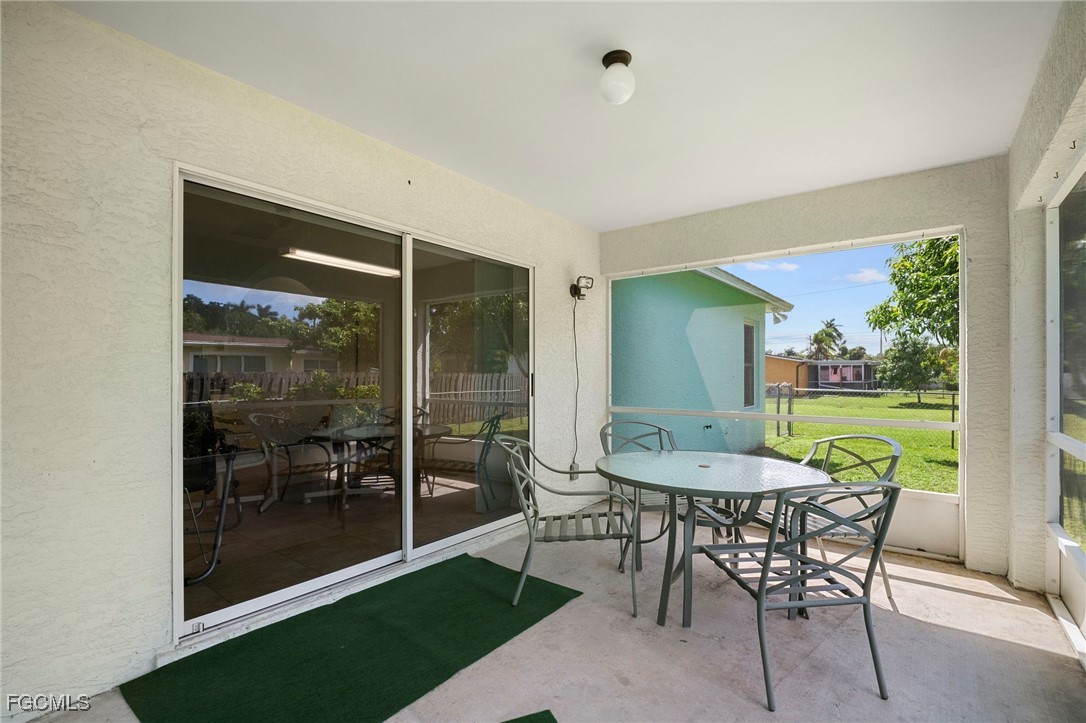 2932 Holly Road Fort Myers, FL 33901 - Photo 21 of 39 a patio with yard glass top table and chairs
