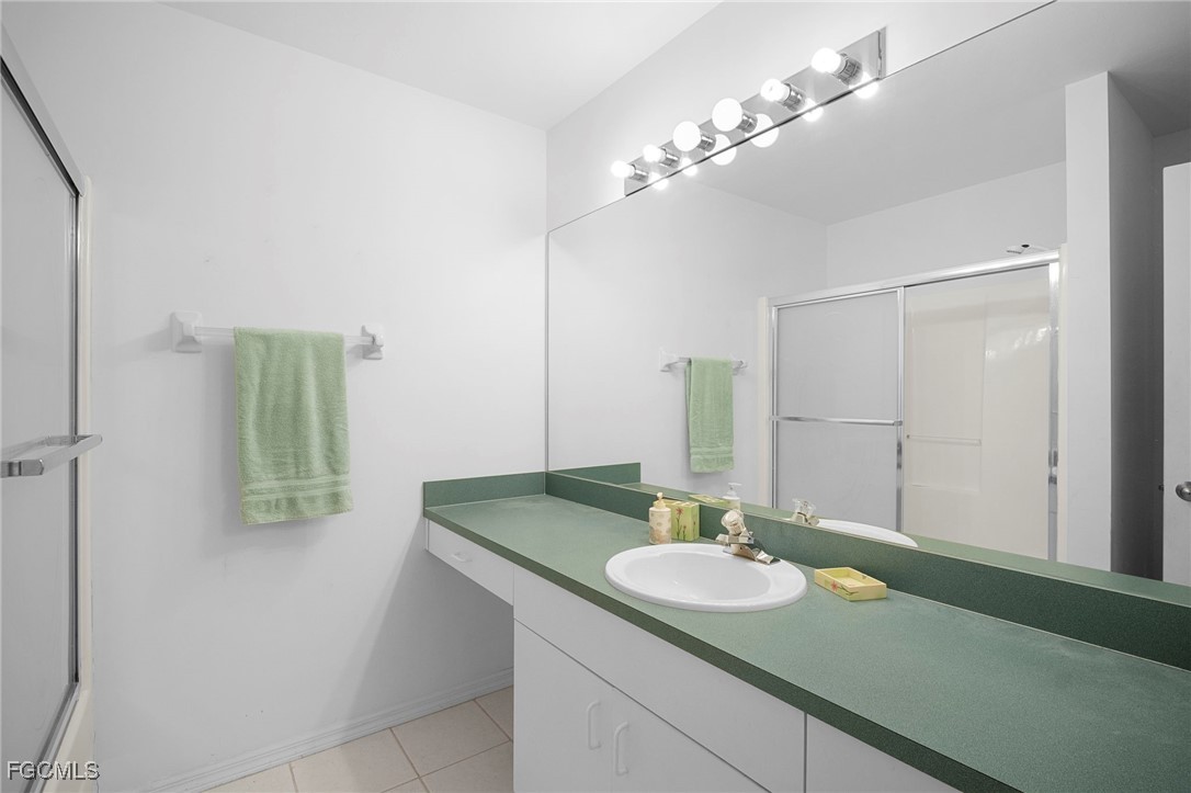 2932 Holly Road Fort Myers, FL 33901 - Photo 26 of 39 a bathroom with a sink and a mirror