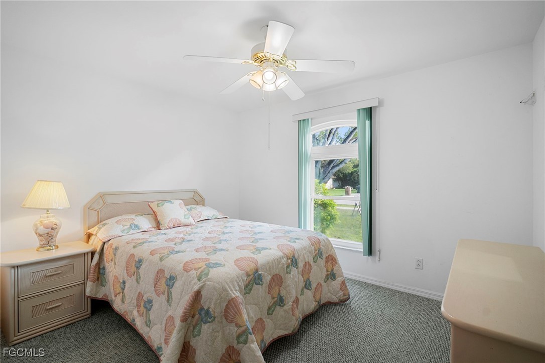 2932 Holly Road Fort Myers, FL 33901 - Photo 29 of 39 a bedroom with a bed and a window