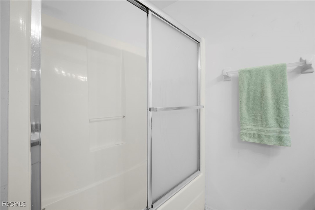 2932 Holly Road Fort Myers, FL 33901 - Photo 32 of 39 a bathroom with a shower and a glass door
