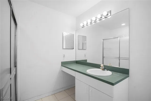 a bathroom with a sink toilet a mirror and shower