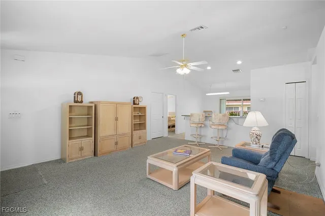 a living room with furniture and chandelier