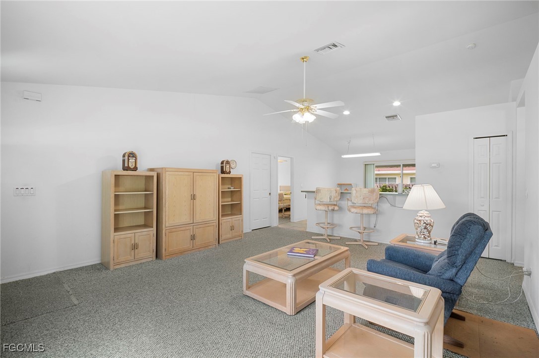 2932 Holly Road Fort Myers, FL 33901 - Photo 5 of 39 a living room with furniture and chandelier