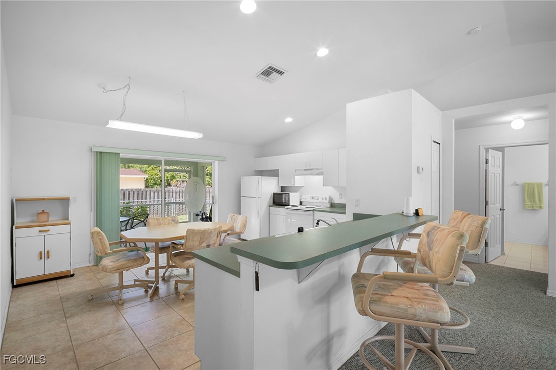 2932 Holly Road Fort Myers, FL 33901 - Photo 7 of 39 a view of a dining room with furniture and a large window