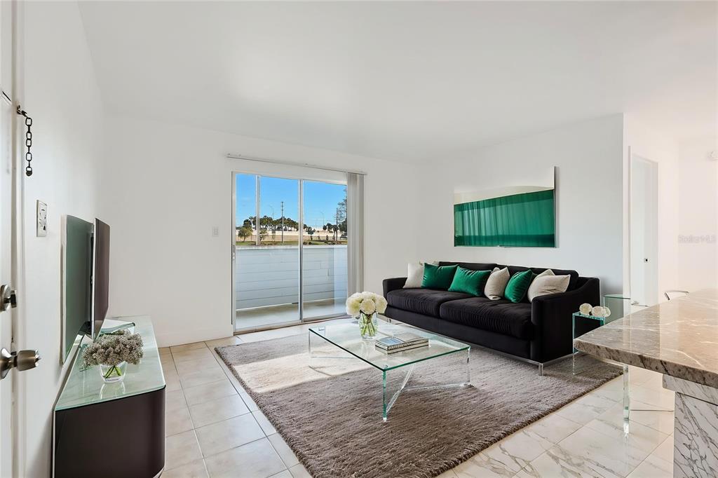 1400 Gandy Boulevard North, Unit 412 St. Petersburg, FL 33702 - Photo 18 of 44 a living room with furniture and a flat screen tv