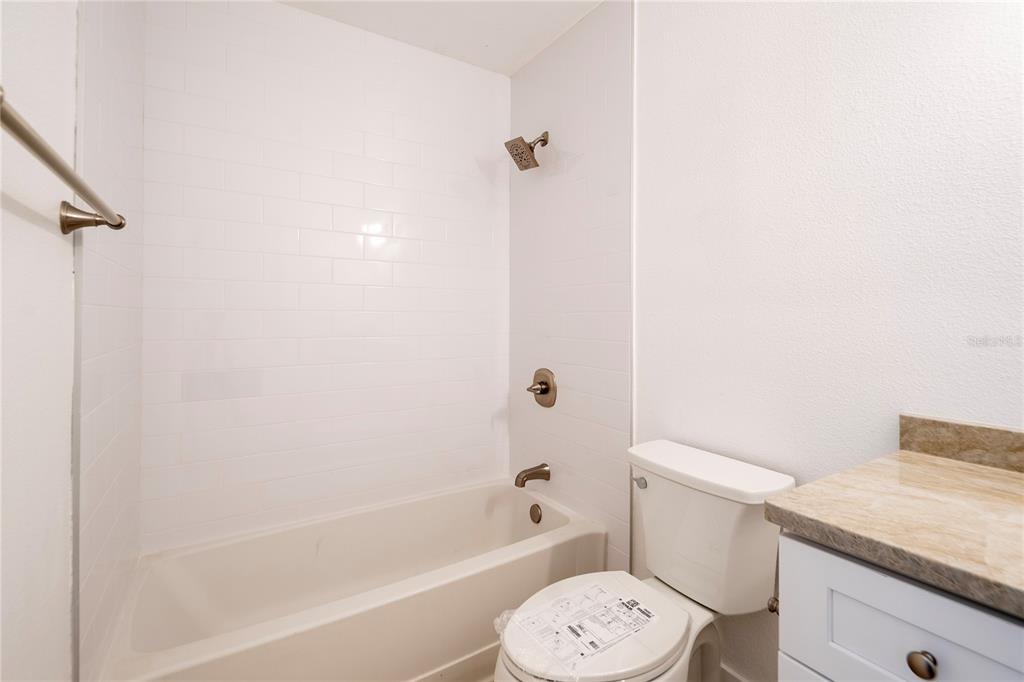 1400 Gandy Boulevard North, Unit 412 St. Petersburg, FL 33702 - Photo 21 of 44 a white toilet sitting next to a bath tub