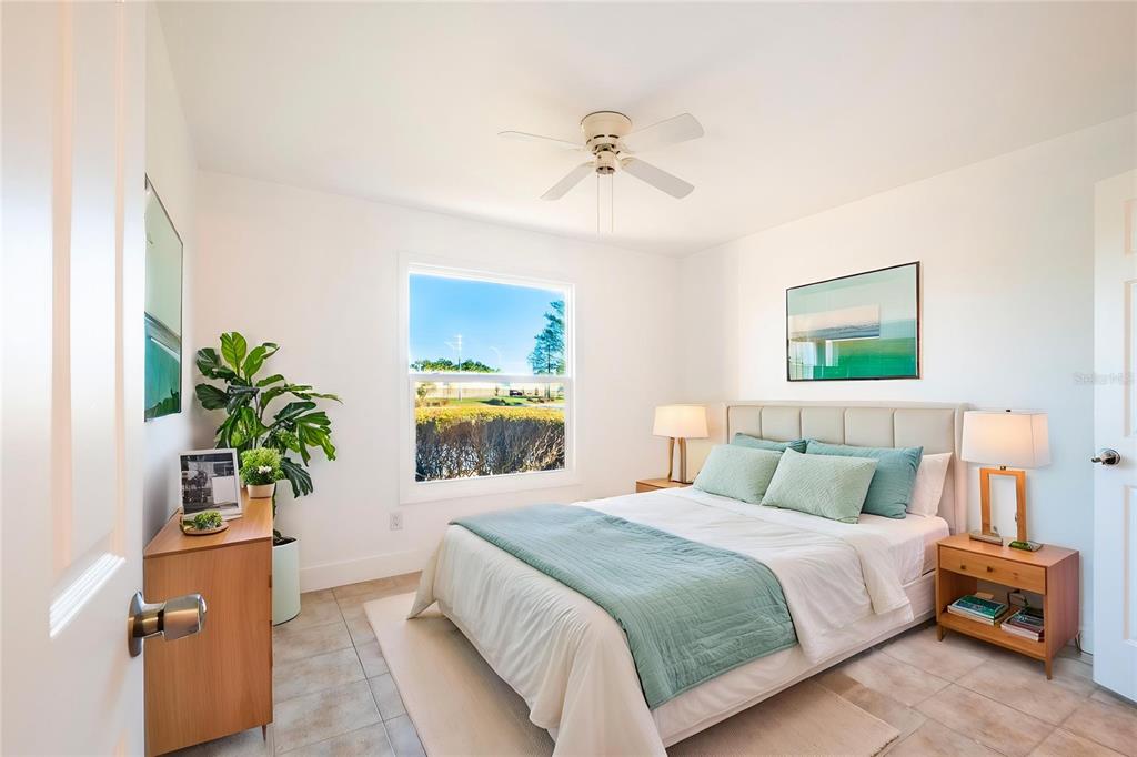 1400 Gandy Boulevard North, Unit 412 St. Petersburg, FL 33702 - Photo 25 of 44 a bedroom with a bed and a potted plant