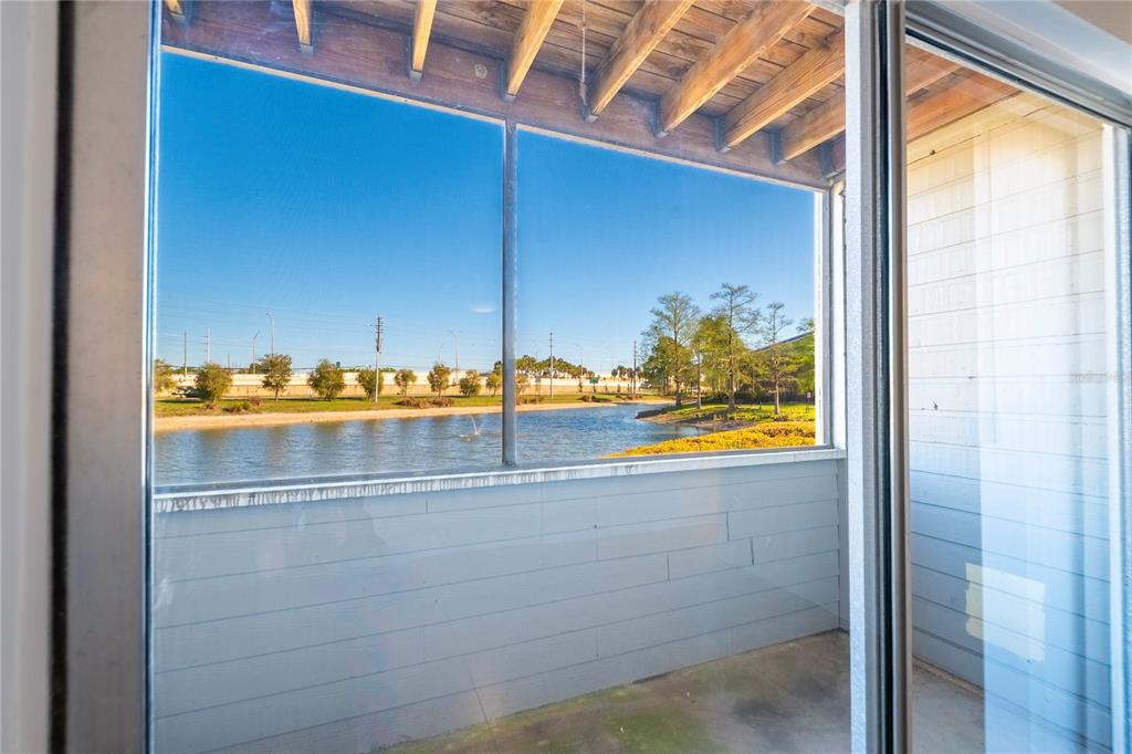 1400 Gandy Boulevard North, Unit 412 St. Petersburg, FL 33702 - Photo 34 of 44 a view of a glass door with a view of the ocean