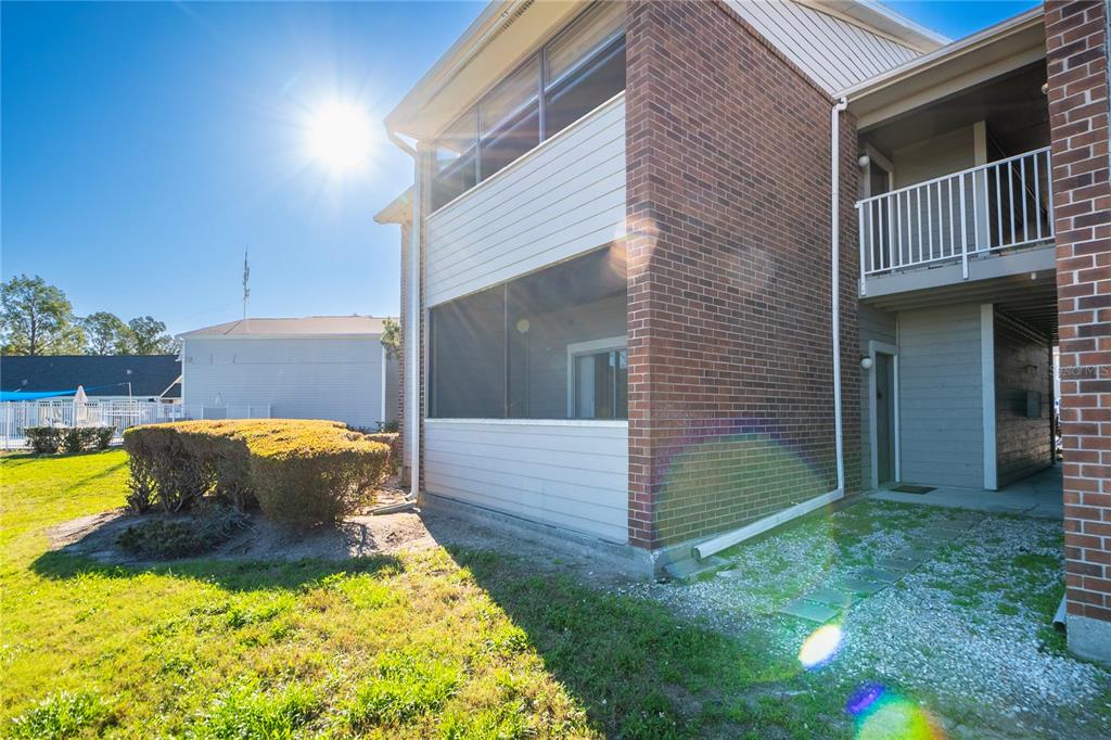 1400 Gandy Boulevard North, Unit 412 St. Petersburg, FL 33702 - Photo 35 of 44 a view of backyard with barbeque grill and wooden fence
