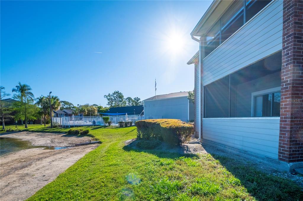 1400 Gandy Boulevard North, Unit 412 St. Petersburg, FL 33702 - Photo 36 of 44 a view of a backyard with couches plants and large tree
