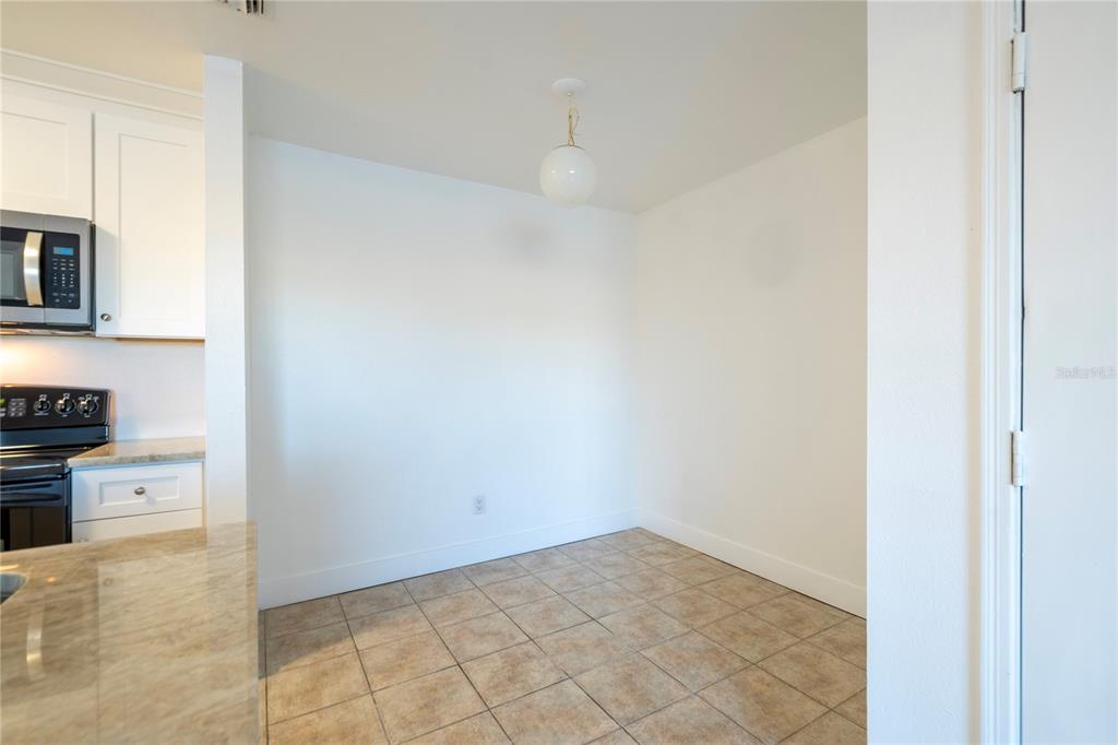 1400 Gandy Boulevard North, Unit 412 St. Petersburg, FL 33702 - Photo 4 of 44 a view of a kitchen with microwave and cabinets