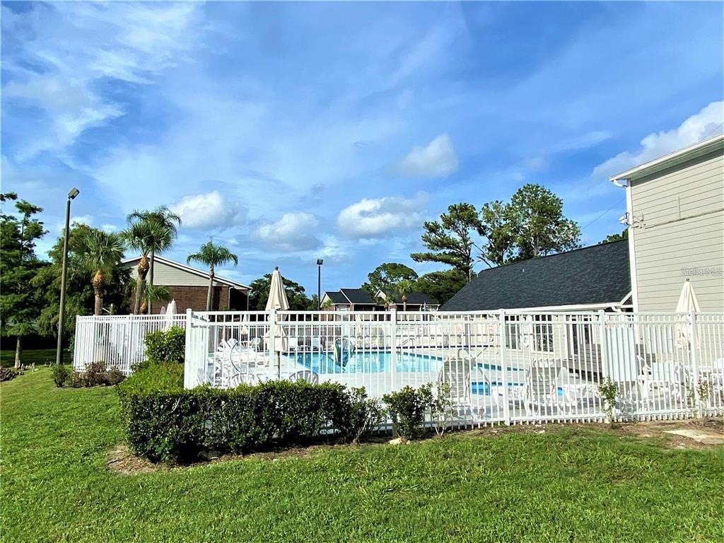 1400 Gandy Boulevard North, Unit 412 St. Petersburg, FL 33702 - Photo 44 of 44 a view of a house with a big yard and a large tree