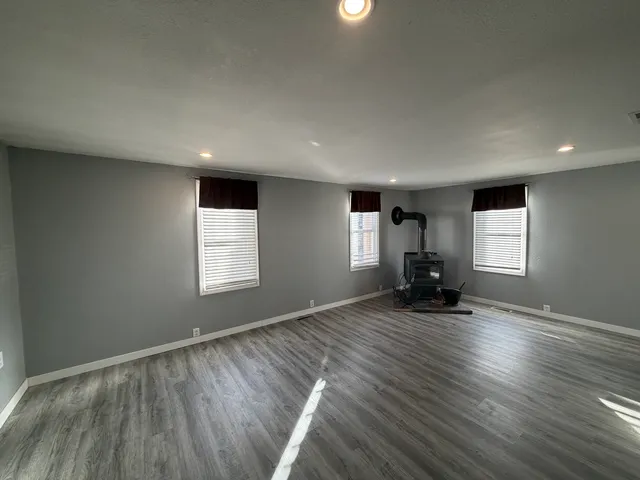 a view of a room with wooden floor and window