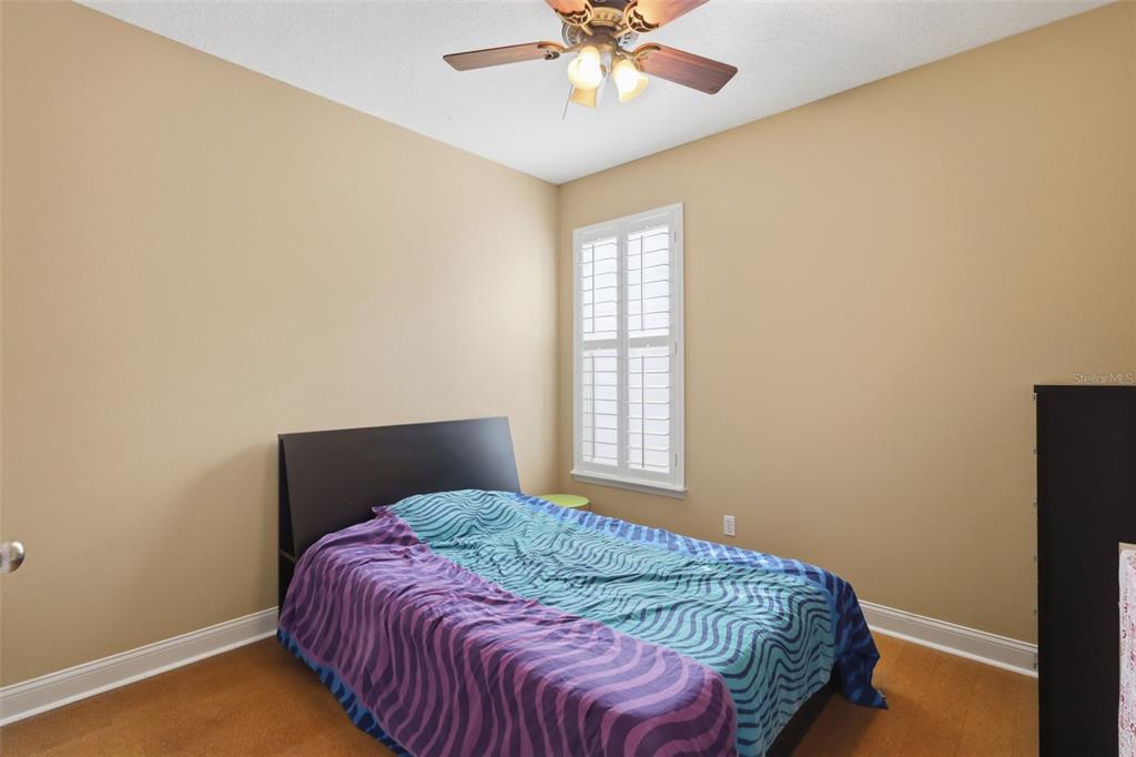 907 Pawstand Road Celebration, FL 34747 - Photo 27 of 49 a bedroom with a bed and a window