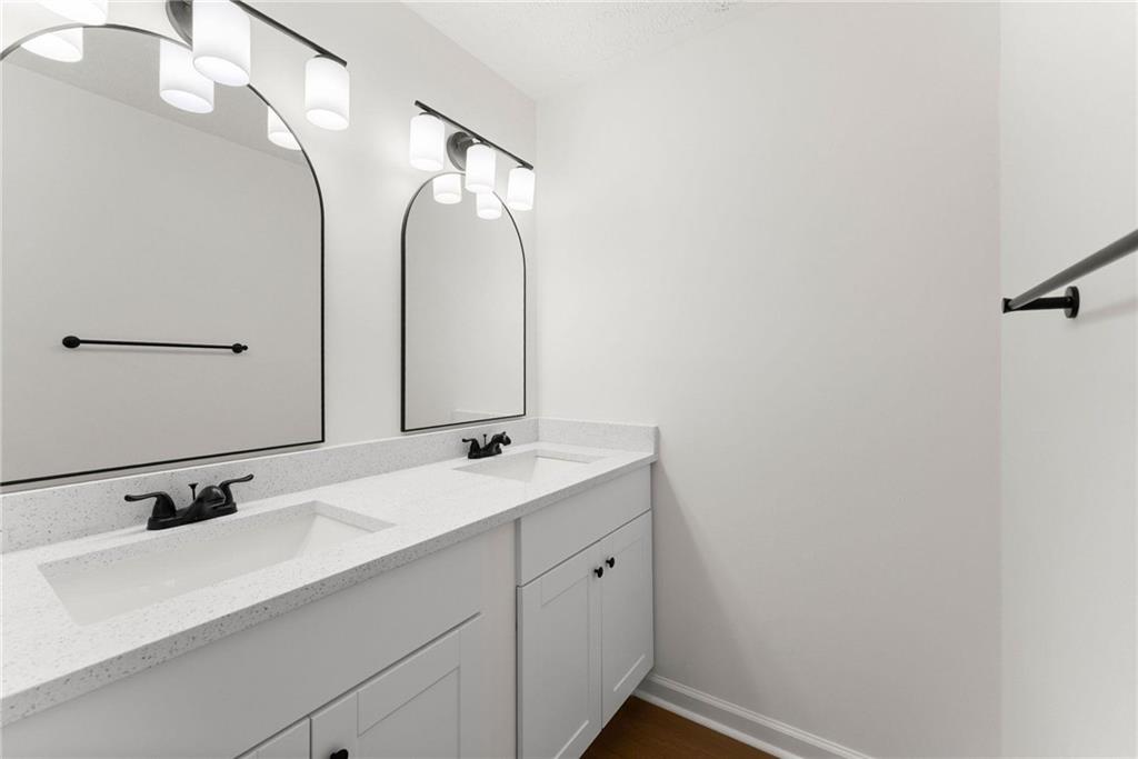 225 Northview Drive Commerce, GA 30529 - Photo 20 of 39 a bathroom with a double vanity sink and mirror