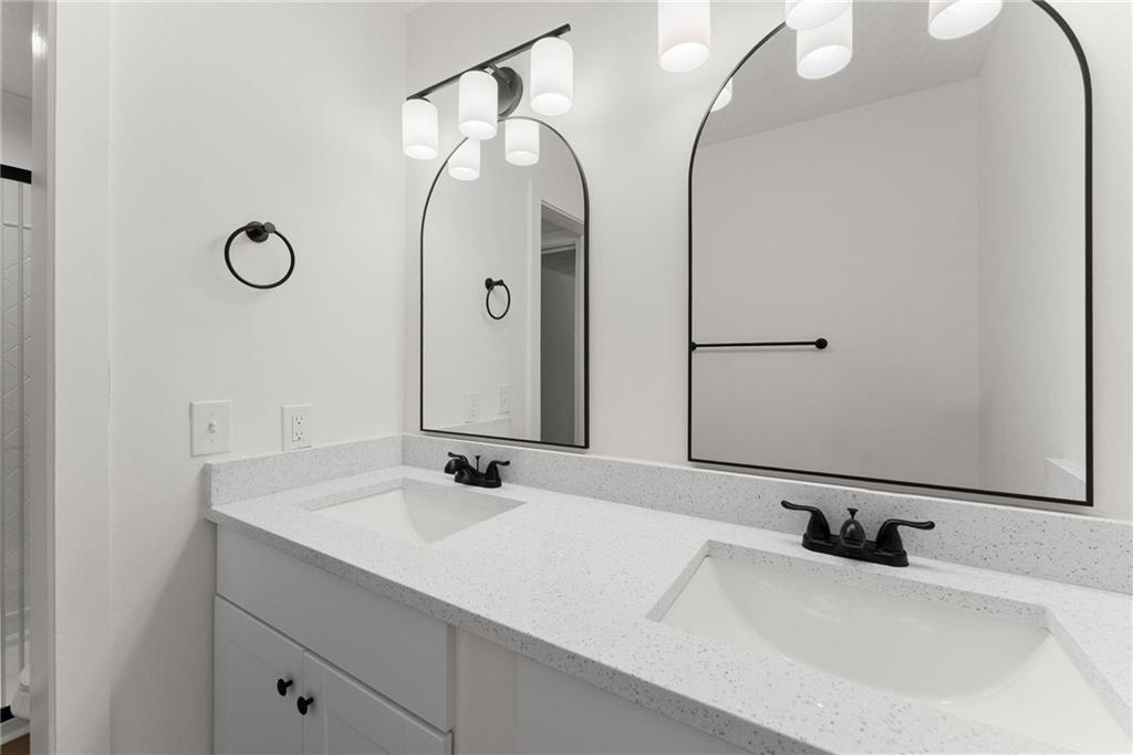 225 Northview Drive Commerce, GA 30529 - Photo 21 of 39 a bathroom with a double vanity sink and a mirror