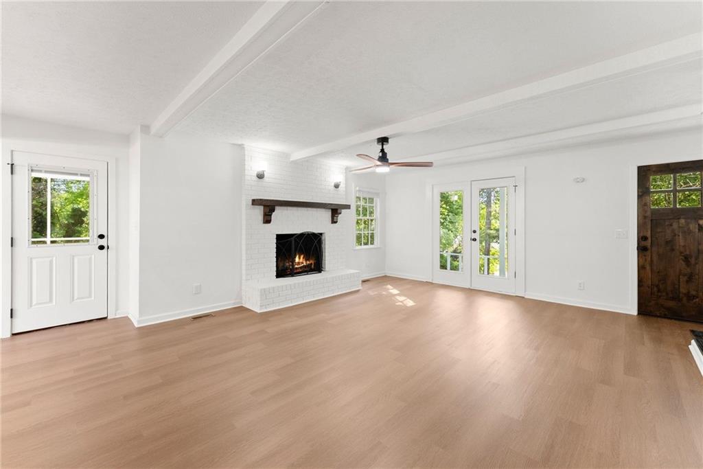 225 Northview Drive Commerce, GA 30529 - Photo 7 of 39 an empty room with windows and fireplace