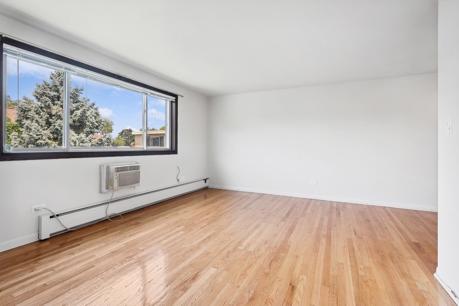 7019 North Ridge Boulevard, Unit 3B Chicago, IL 60645 - Photo 2 of 9 a view of empty room with wooden floor and fan
