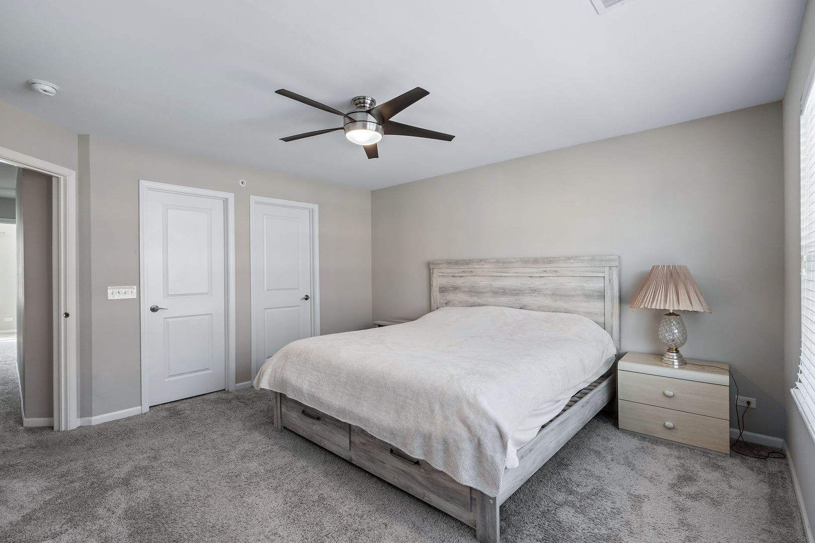 830 Center Street Des Plaines, IL 60016 - Photo 12 of 16 a bedroom with a bed and a lamp on table