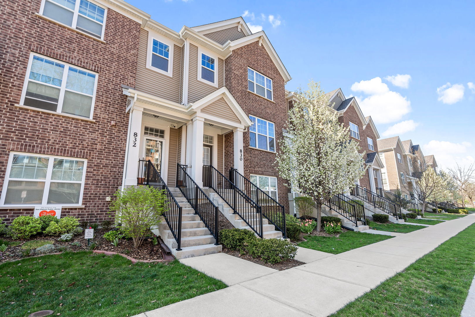 830 Center Street Des Plaines, IL 60016 - Photo 2 of 16 a front view of a multi story residential apartment building with yard and green space