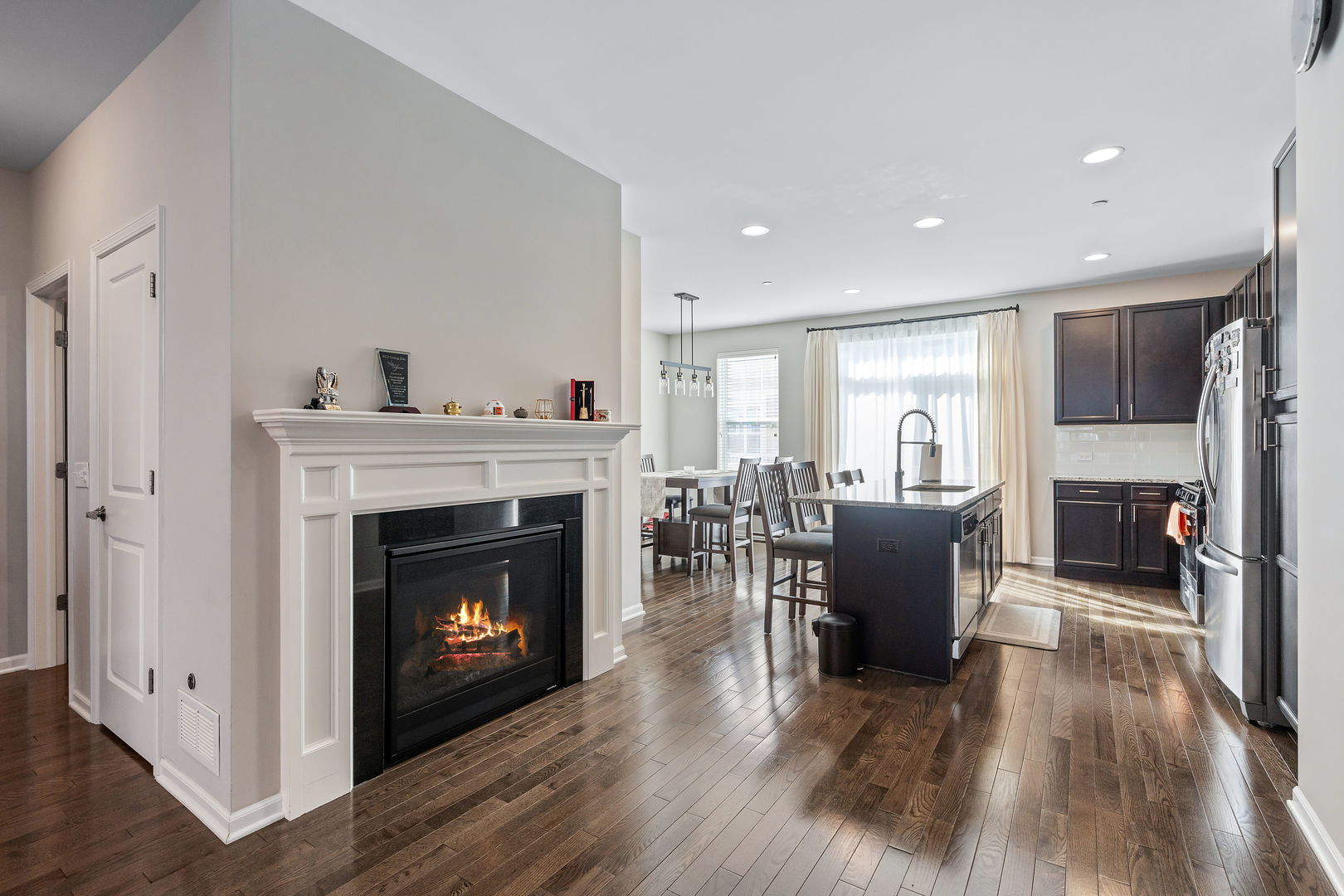 830 Center Street Des Plaines, IL 60016 - Photo 4 of 16 a living room with furniture a fireplace and a dining table with wooden floor