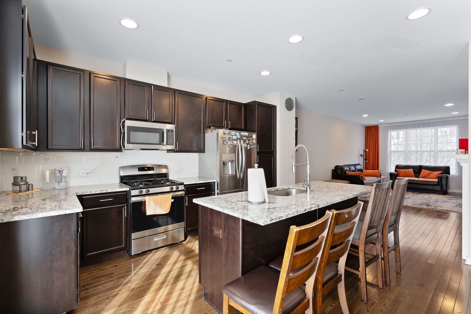 830 Center Street Des Plaines, IL 60016 - Photo 8 of 16 a kitchen with stainless steel appliances kitchen island granite countertop a sink dishwasher a stove a refrigerator with a dining table and chairs