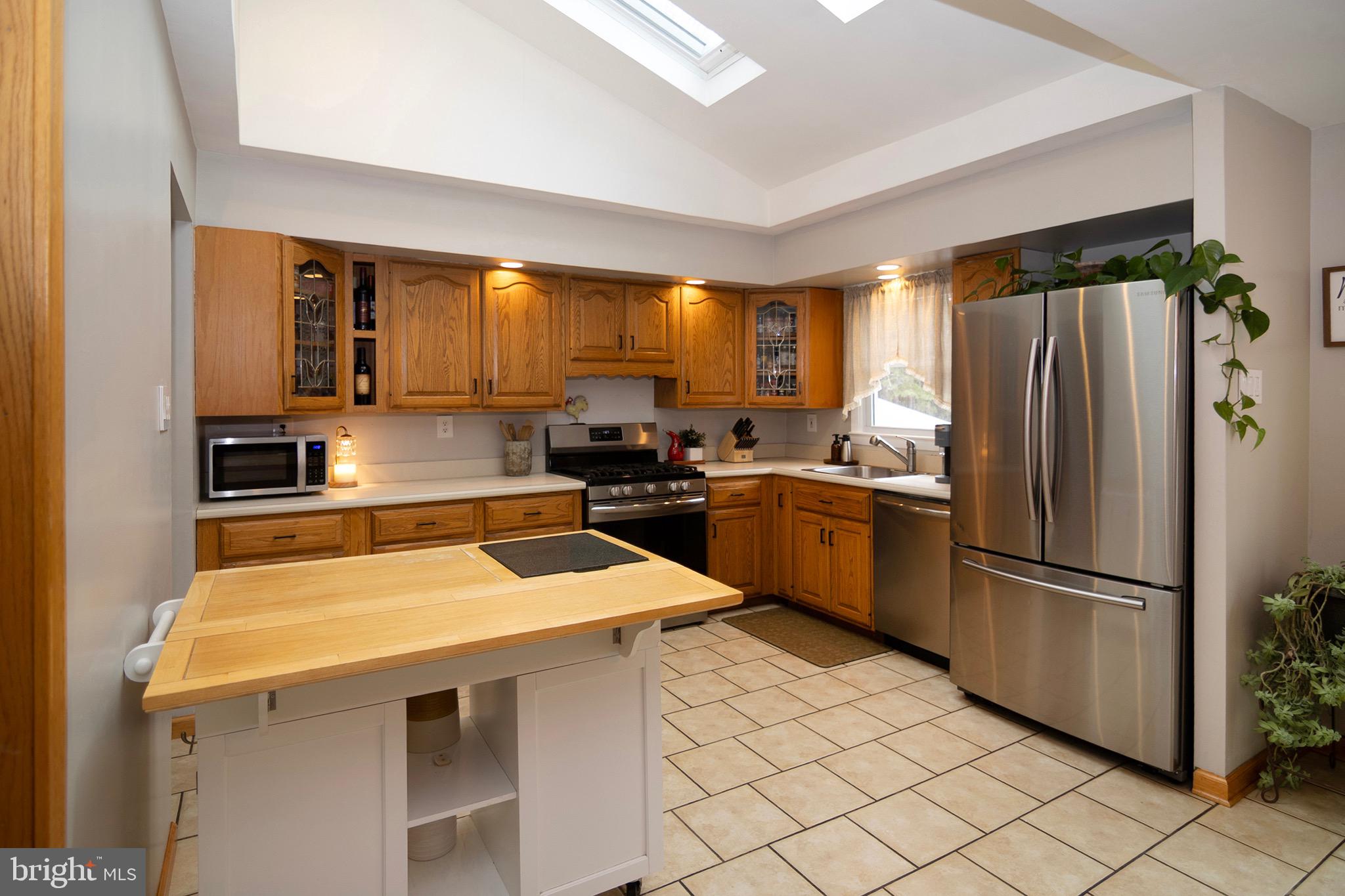 4643 Jackson Road Williamstown, NJ 08094 - Photo 15 of 74 a kitchen with a sink a counter top space stainless steel appliances and cabinets