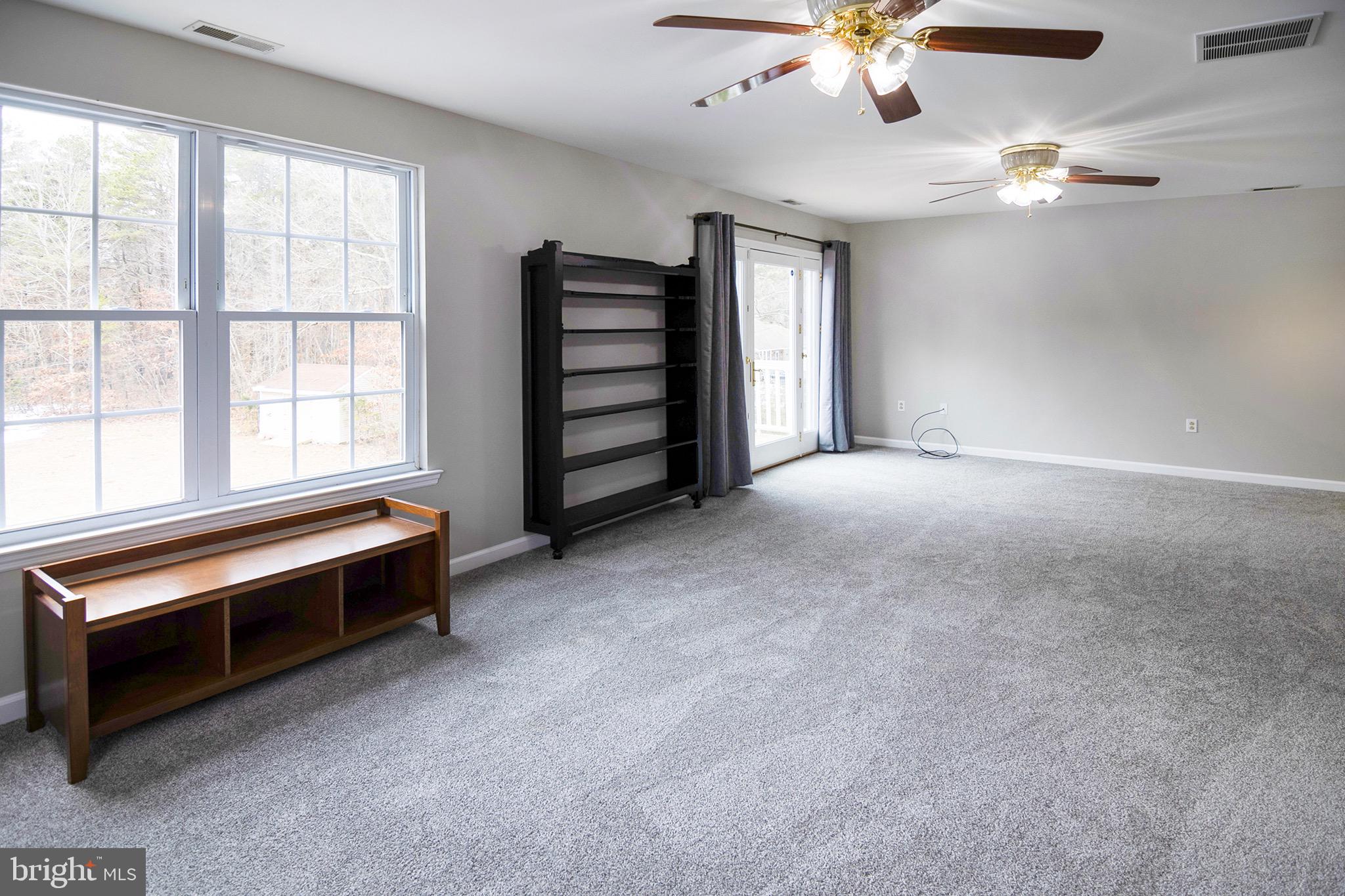 4643 Jackson Road Williamstown, NJ 08094 - Photo 49 of 74 an empty room with chandelier fan and windows