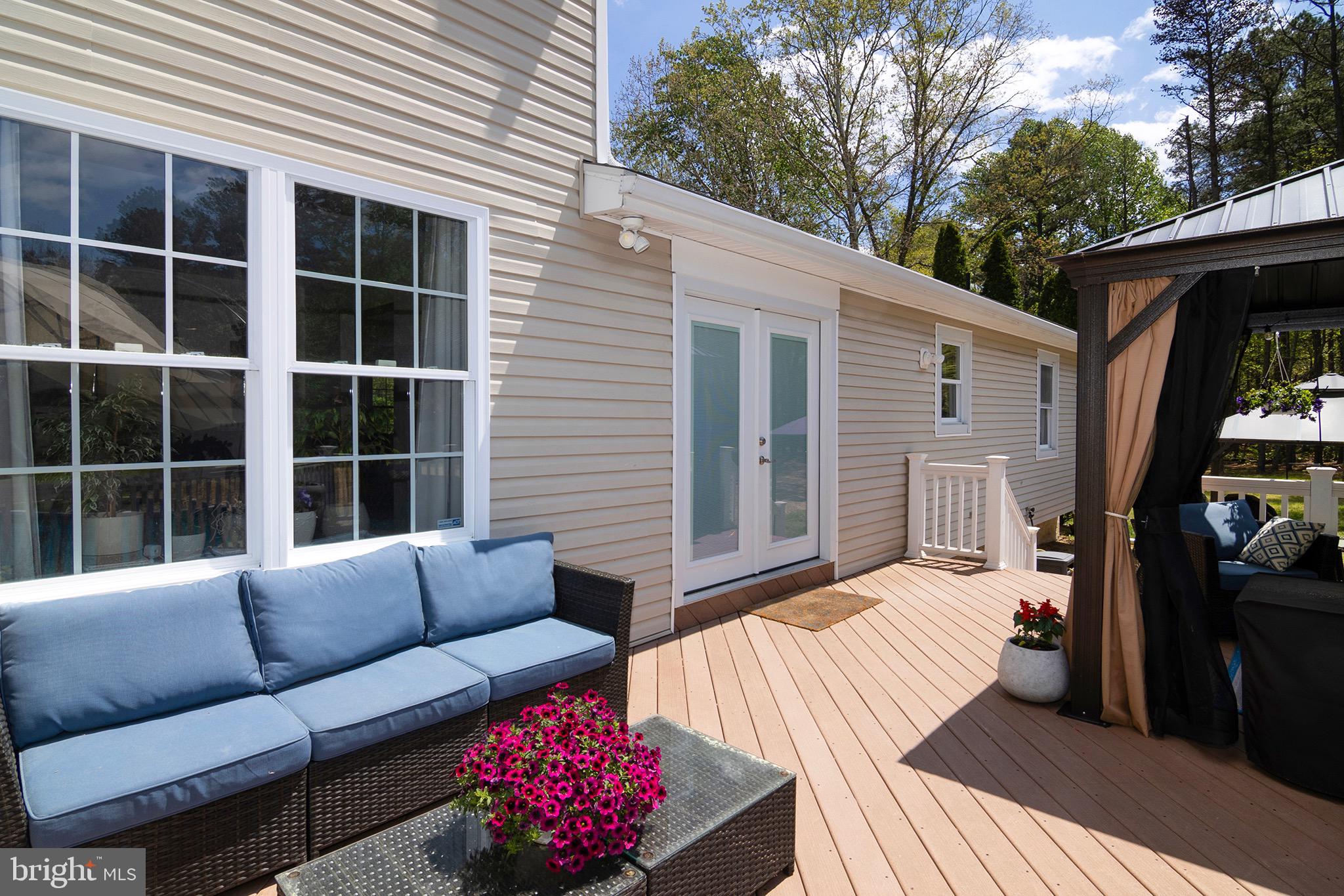 4643 Jackson Road Williamstown, NJ 08094 - Photo 65 of 74 a view of a patio with couches chairs potted plants and a large tree