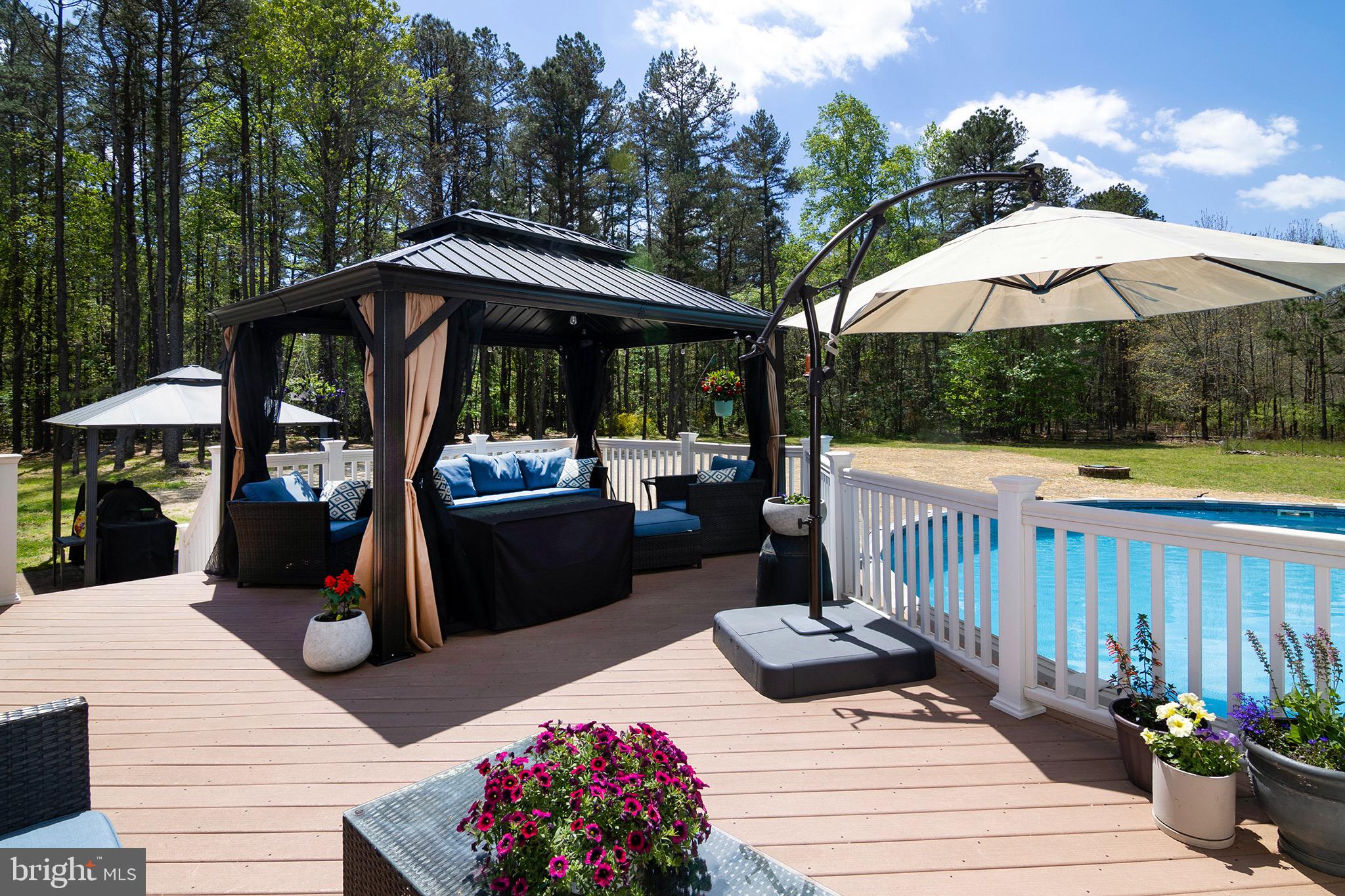 4643 Jackson Road Williamstown, NJ 08094 - Photo 68 of 74 a view of a table and chairs under an umbrella in the patio