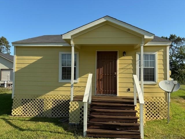 a front view of a house with a bench