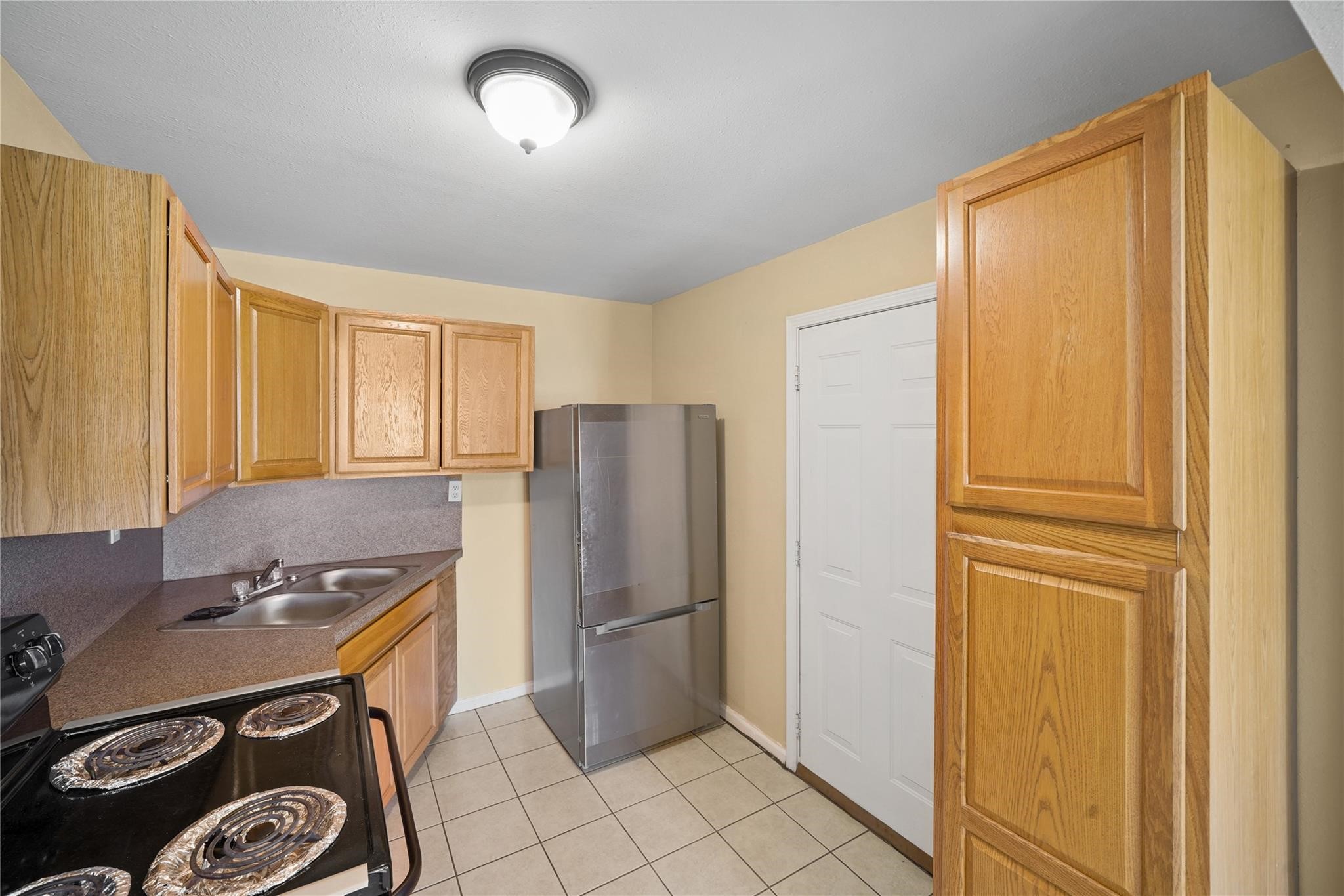 3521 Lebadie Street Houston, TX 77026 - Photo 5 of 9 a kitchen with a refrigerator and a stove top oven