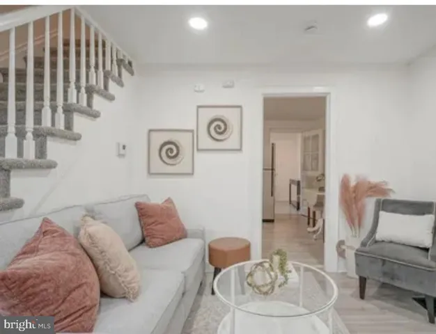 a living room with furniture and a painting